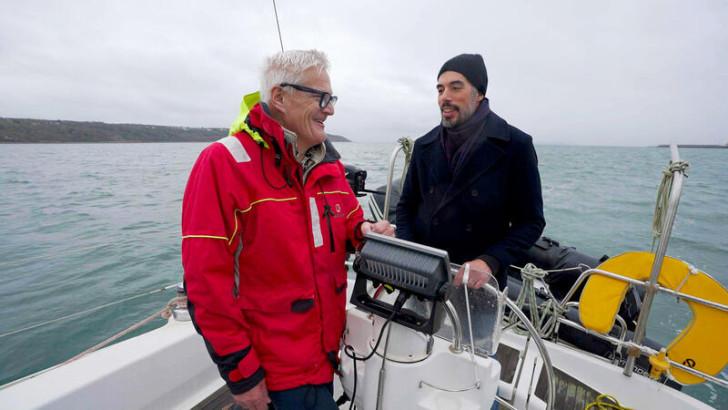 Bertrand et Joseph discutant à bord d'un voilier 